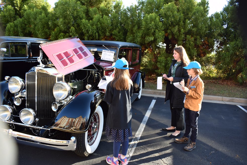 2022Fall_1077.JPG - Junior judges — Jeanette, Sonner, Garrett Sonner, and Anne Sonner, and Crimora Fingerholz — evaluate Lynn Shirey’s 1934 Super Eight sedan, which later won the Ladies’ Choice Award.