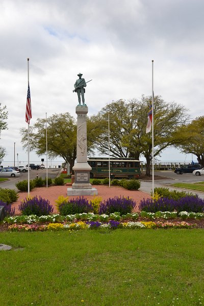 DSC_0029.JPG - Edenton's Confederate Soldier monument at the waterfront with the Tour Trolley behind.  Flags at half-mast for Barbara Bush.