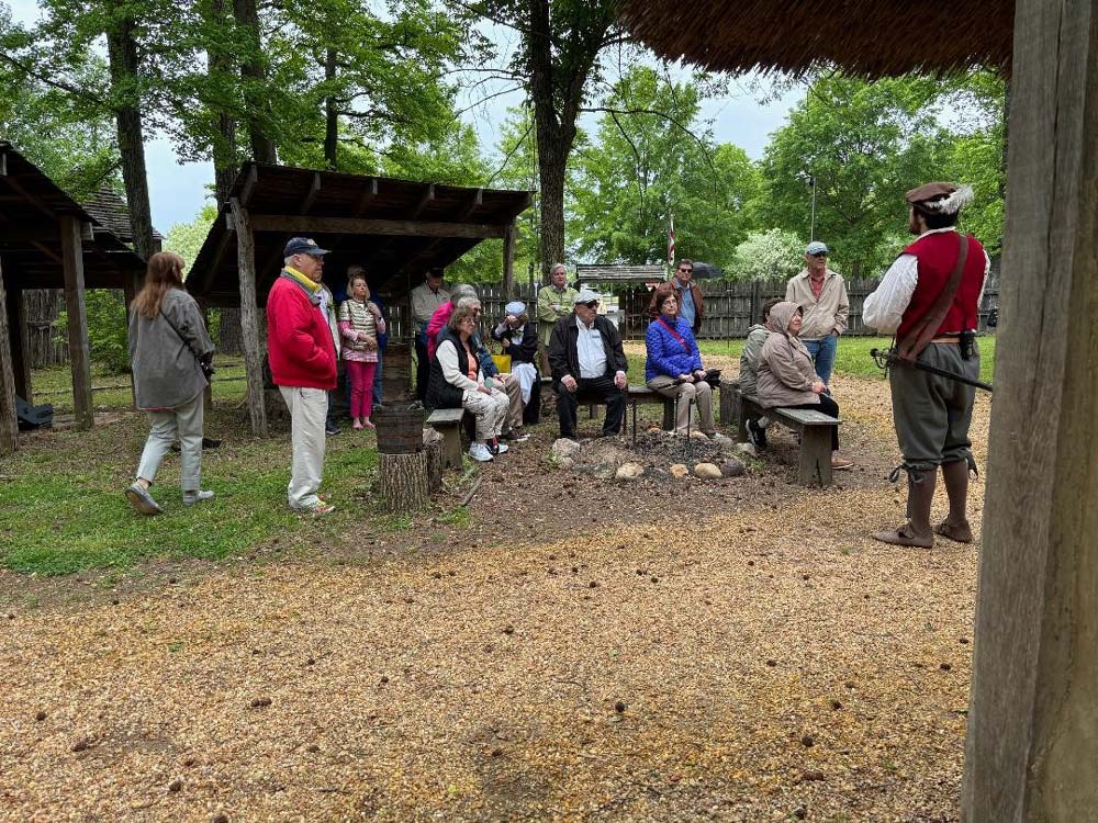 79.jpg - Members listen to information about farming at the Henricus settlement.